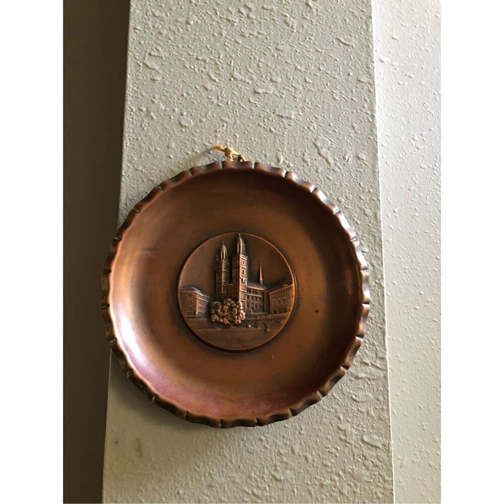 Sigg Switzerland vintage hanging decorative plate brass color 8”